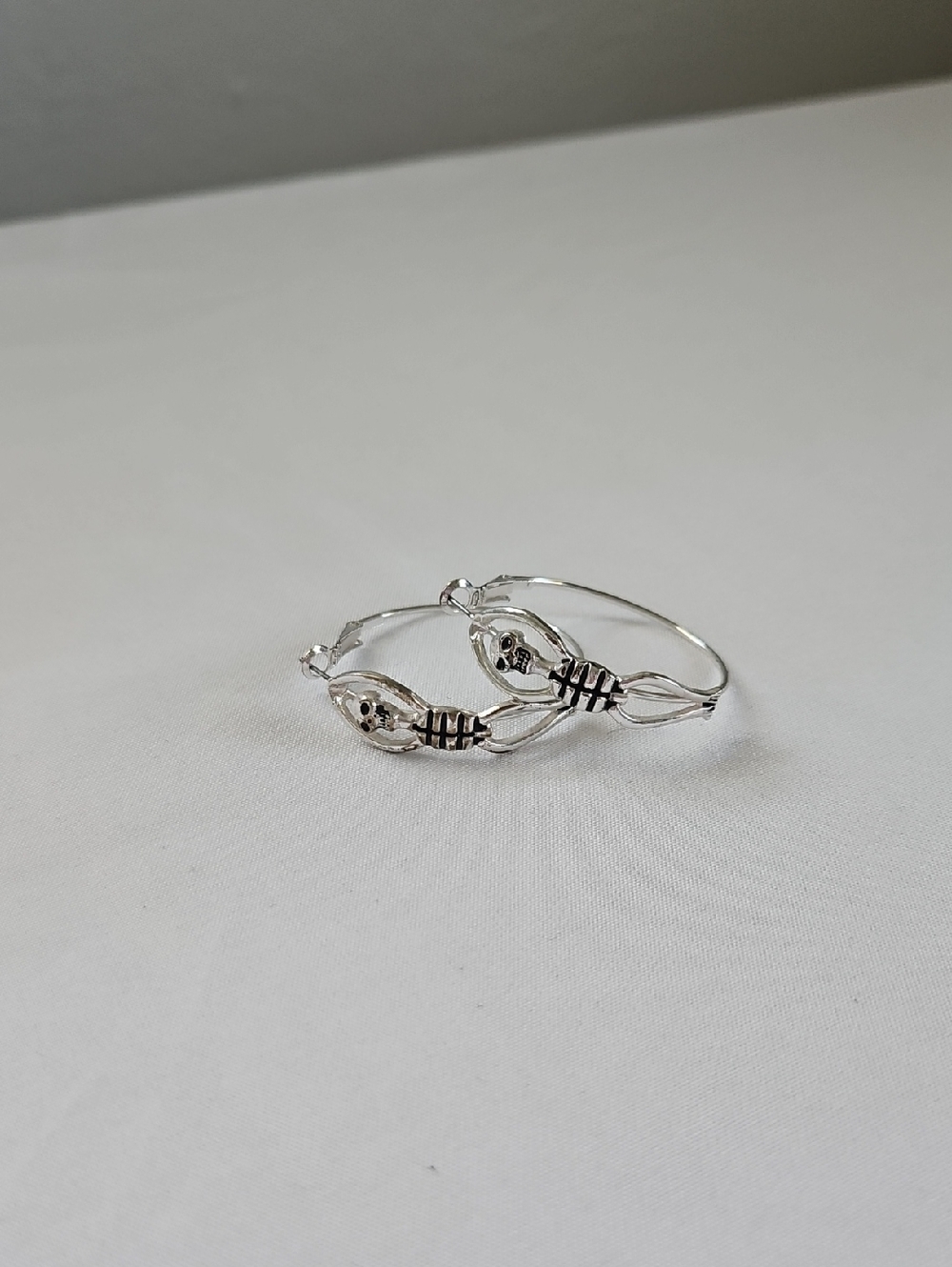 Silver-Tone Twist Hoop Earrings with Skeleton Detail